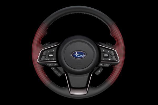 Iliustracija, rodanti aktyvias šildymo vielas Subaru vairuotojo vairale.